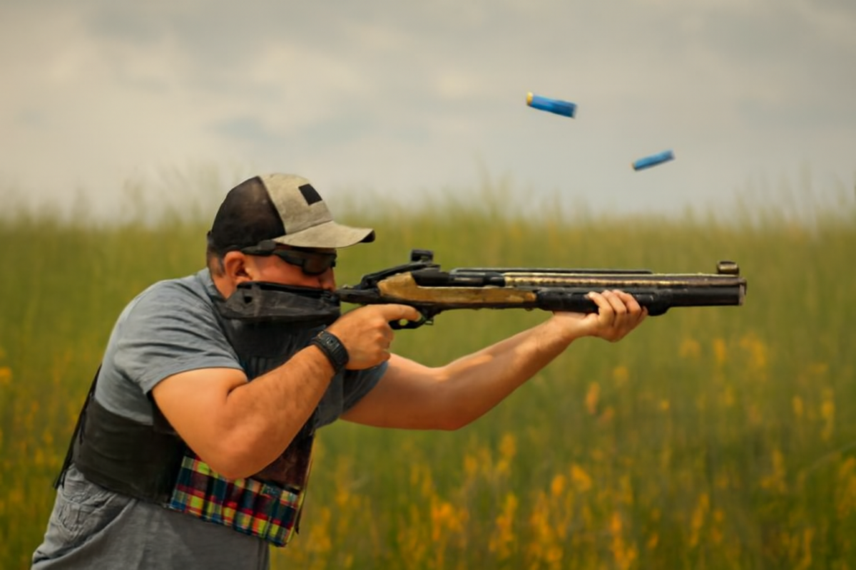 Man shooting a tactical shotgun with shells ejecting